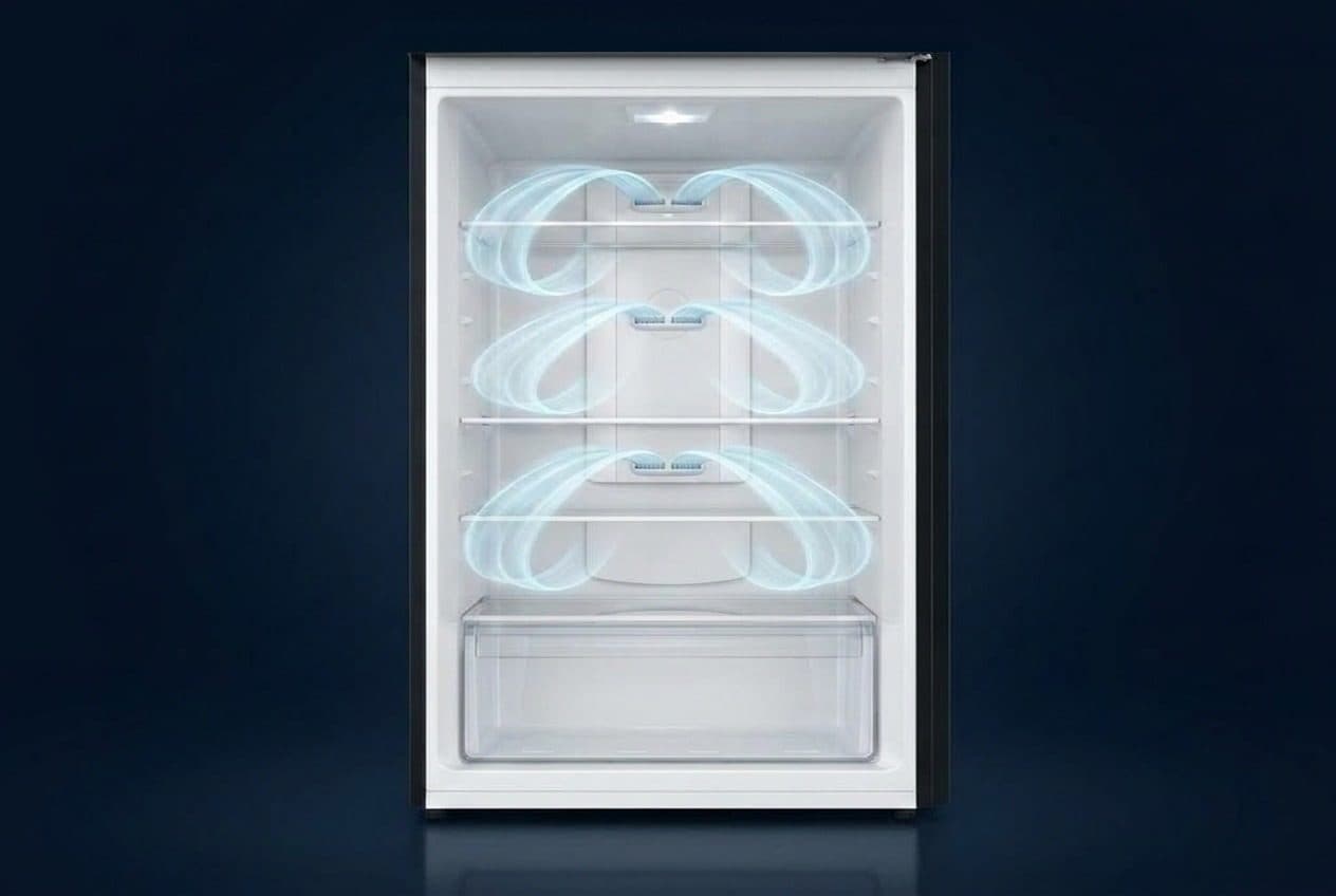 A front-on open top-mount fridge interior in a navy studio, with white liner, three glass shelves and a crisper drawer, each shelf with a pair of back-wall vents sending translucent blue ribbons that curl inside the liner and return toward the back wall.
